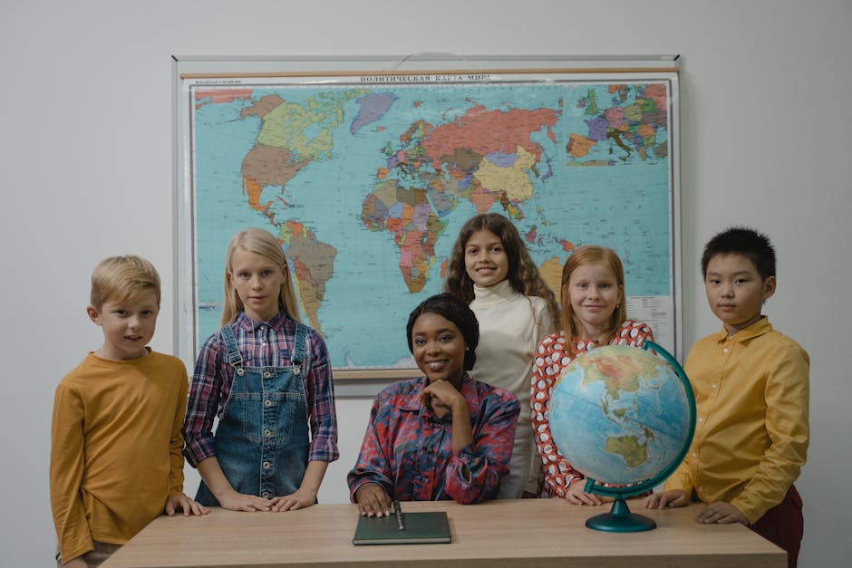 A diverse group of students with a teacher in a classroom setting featuring a globe and world map